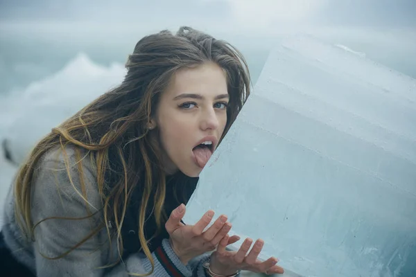 Woman with pretty face lick ice block. — Stock Photo, Image