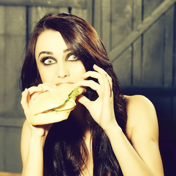 Sexy woman eating burger