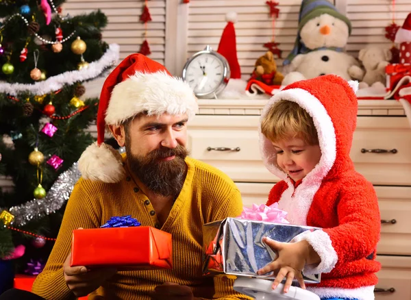 Christmas happy child and father with present box.