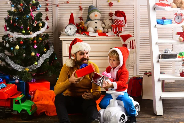 Christmas happy child and father with present box.