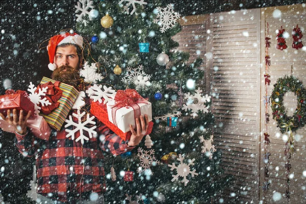 Christmas man with beard on face hold gift.