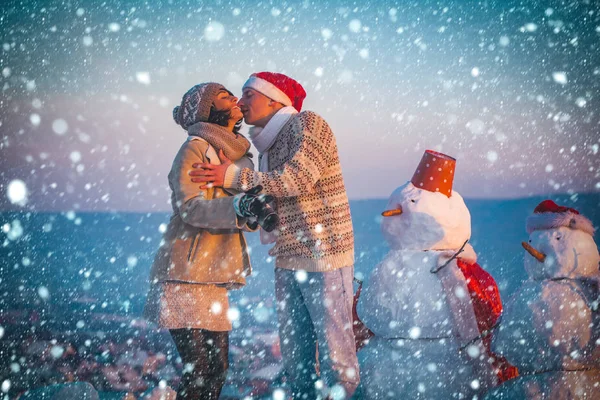 Santa musculoso hombre y chica con muñeco de nieve — Foto de Stock
