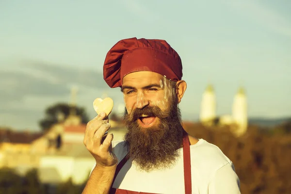 bearded cook with dough heart