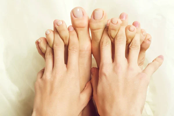 Female fingers between toes