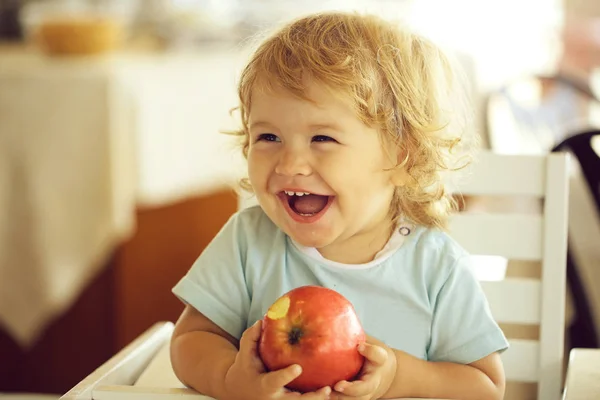 Смеющийся мальчик с яблоком — стоковое фото