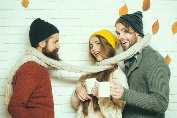 Happy friends at autumn leaves in scarf and hat. — Stock Photo, Image