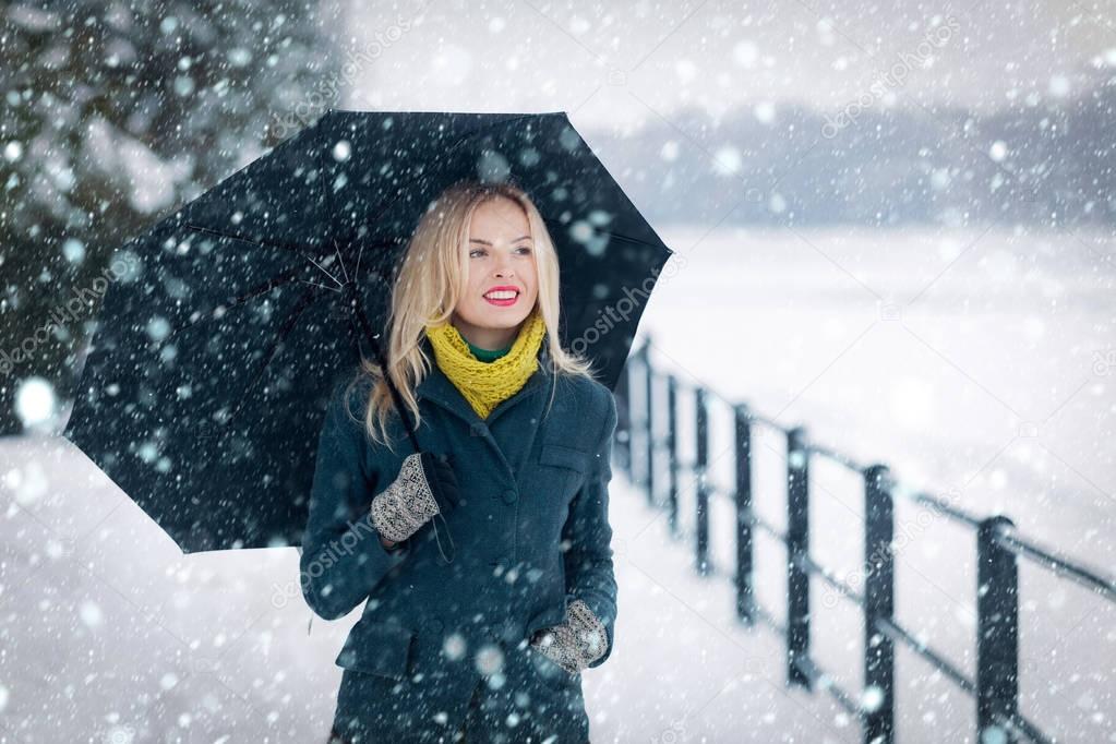 Woman with long blond hair on white snow landscape