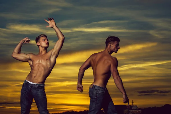 Muscular men in sunset with boxes — Stock Photo, Image