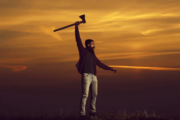 Man with axe on sunset — Stock Photo, Image