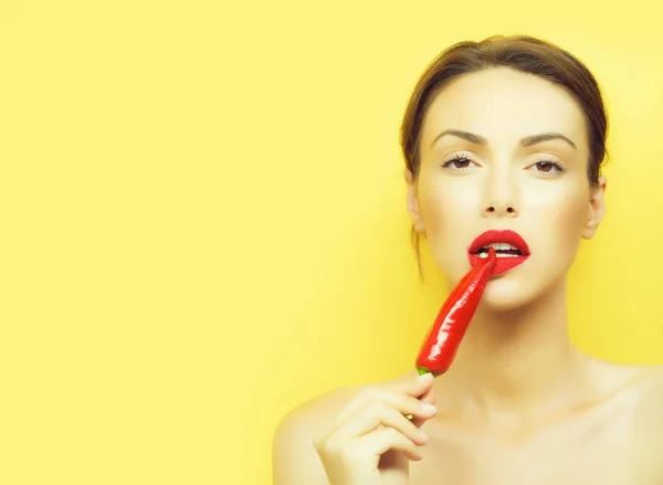 Girl with red chilli pepper — Stock Photo, Image