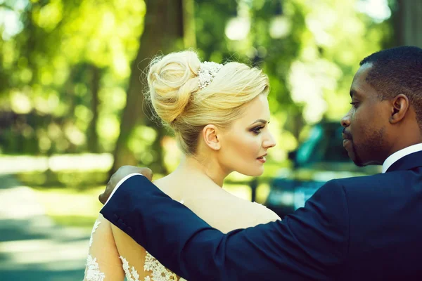 Milující ženich se dotýká ramene rozkošná nevěsta — Stock fotografie