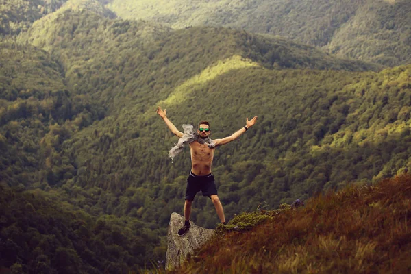 Handsome guy on mountain slope — Stock Photo, Image