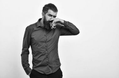 ciddi sakallı adam hipster viski bardağında turuncu gömlek ile