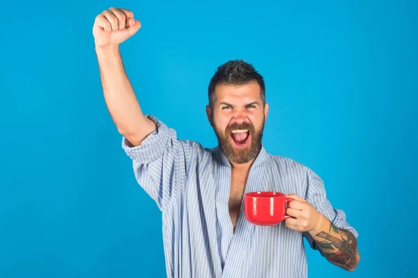 Bearded hipster with red milk cup. — Stock Photo, Image