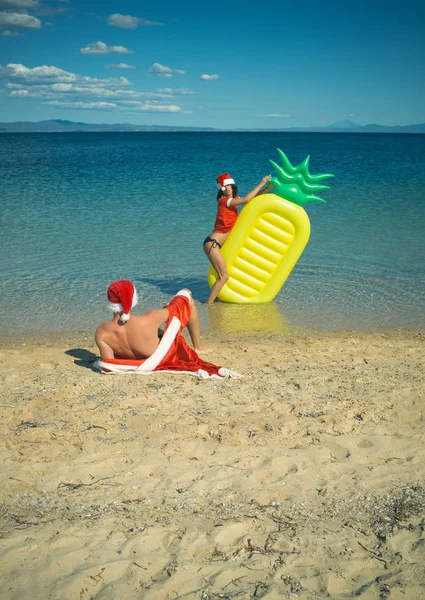 New year girl and guy as santa — Stock Photo, Image