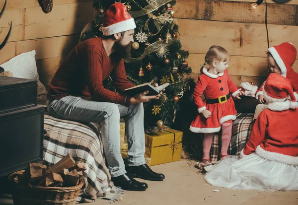 Christmas happy children and father read book.