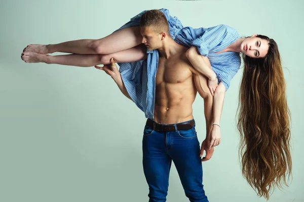 Macho hold woman with long hair on shoulder — Stock Photo, Image