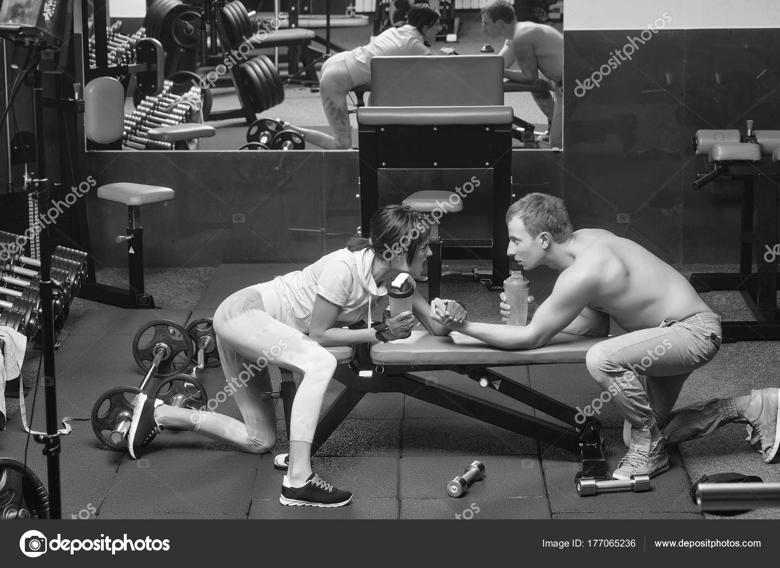 Arm Wrestling Muscular Man And Girl At Gym Stock Photo