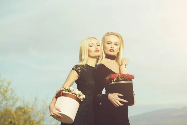Meninas bonitas com flores na caixa — Fotografia de Stock