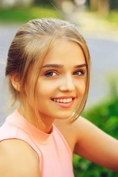 Blonde girl in pink shirt — Stock Photo, Image