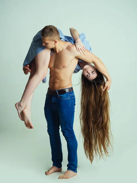 Женщина с длинными волосами висит на сильном плече мужчины — стоковое фото