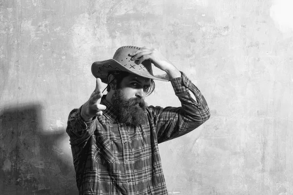 Bearded man with long beard in cowboy hat