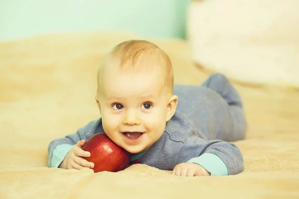 Little happy baby with red apple — Stock Photo, Image