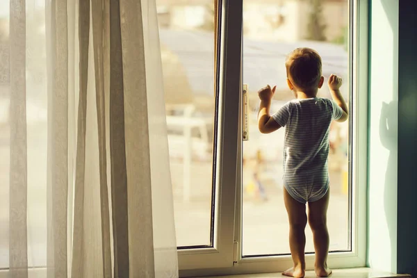 Baby boy on window sill — Stock Photo, Image