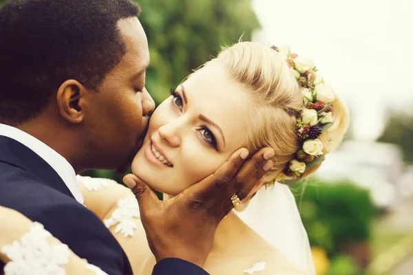 Groom kisses face of bride — Stock Photo, Image