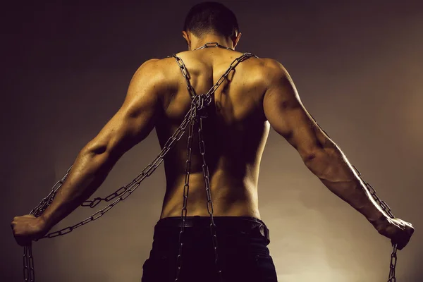 Muscular guy with chain on back