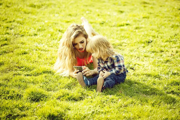 Young Woman Little Boy Mobile Phone Lying Field Green Grass — Stock Photo, Image