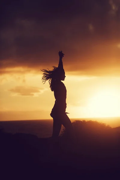 Black silhouette of pretty girl at idyllic sunset — Stock Photo, Image