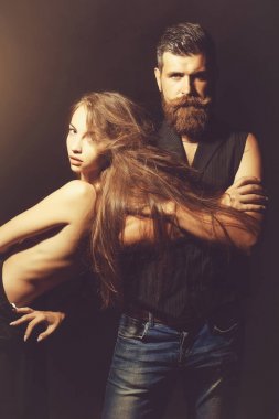 genç bir kaç yakışıklı sakallı adam hipster sakal ve bıyık kot pantolon ve oldukça seksi kadın veya kız uzun saçlı ve siyah arka plan üzerinde elbise kırmızı dudaklar ile çıplak sırt