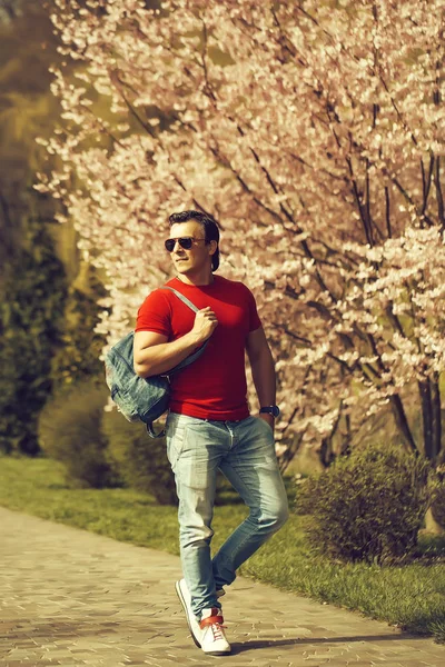 Stylish man ner blooming tree — Stock Photo, Image