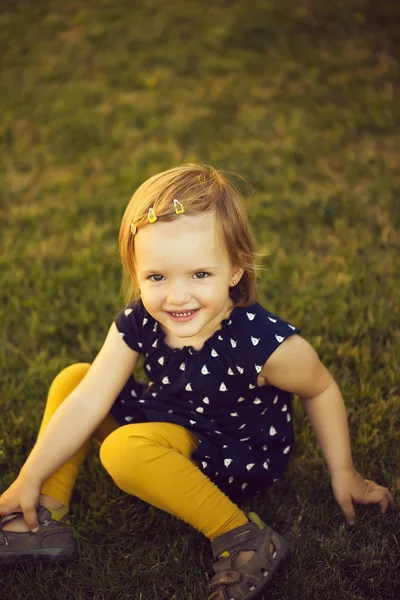 Cute baby girl on grass — Stock Photo, Image