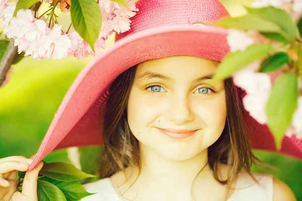 Girl in hat with bloom — Stock Photo, Image