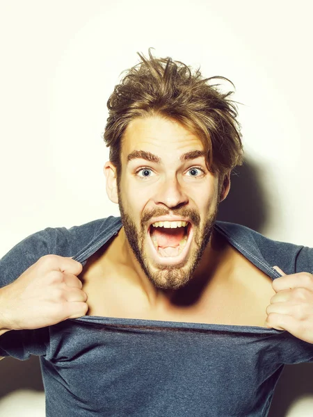 Excited man rips tshirt open — Stock Photo, Image