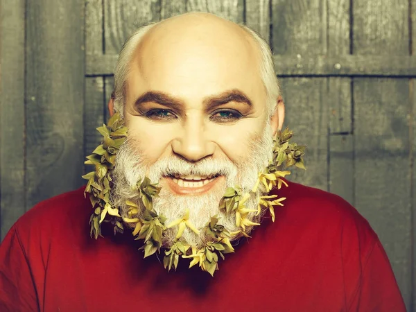 old man with flowers and leaves in beard