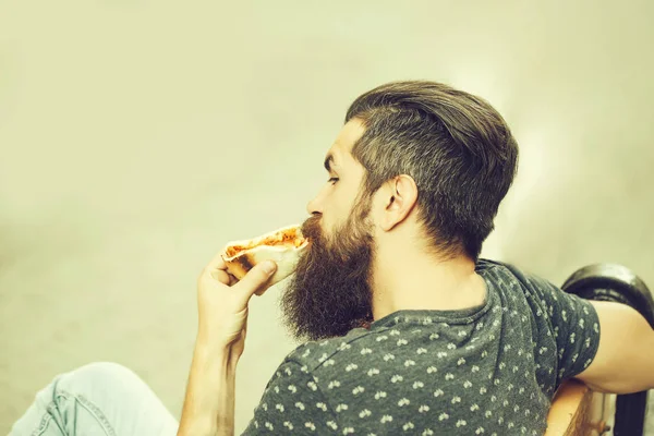 Knappe bebaarde man eten pizza — Stockfoto