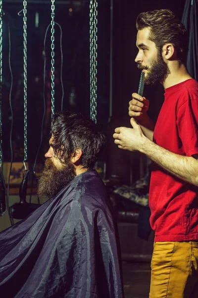 Barber cuts hair to man