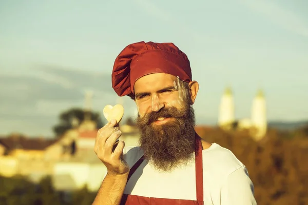 bearded cook with dough heart