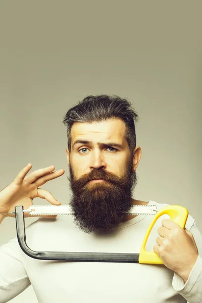 Bearded man with saw — Stock Photo, Image