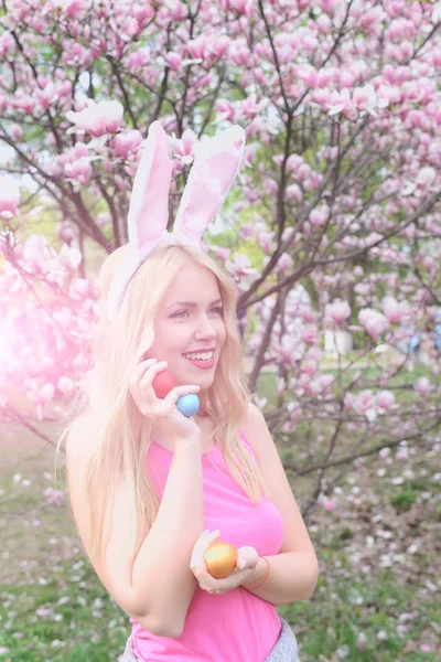 Meisje glimlachend met kleurrijke eieren in bunny oren — Stockfoto