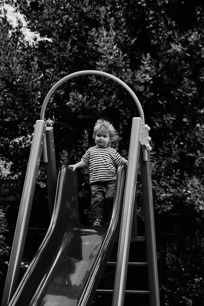 Bonito menino no slide — Fotografia de Stock