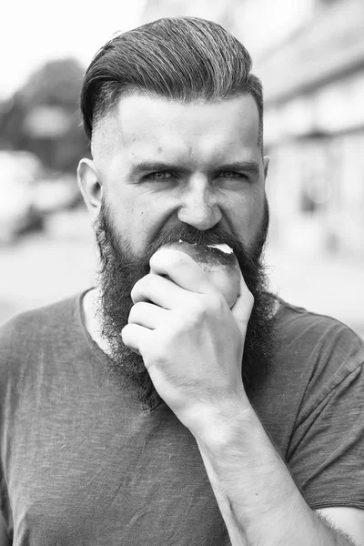 Bearded man eating apple