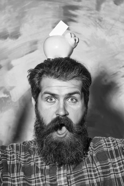 Şaşırmış sakallı adam ile kafasına pembe seramik kumbara