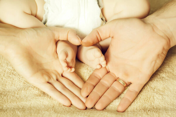 Newborn feet in parent hands