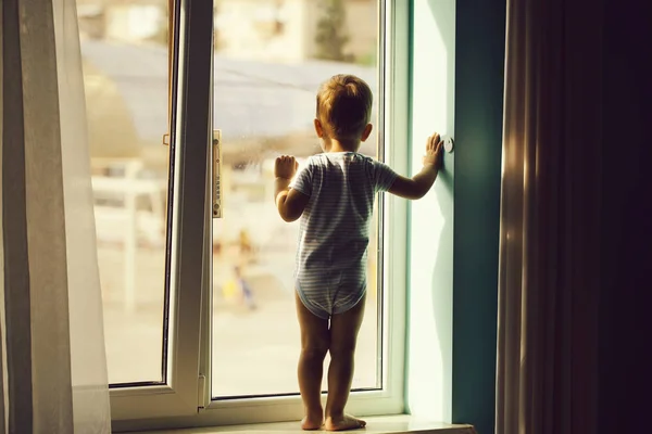 Baby boy on window sill — Stock Photo, Image