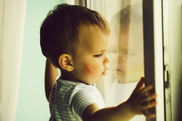 Baby boy on window sill — Stock Photo, Image