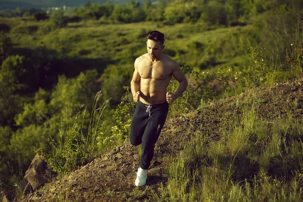Sexy muscular man running outdoor — Stock Photo, Image